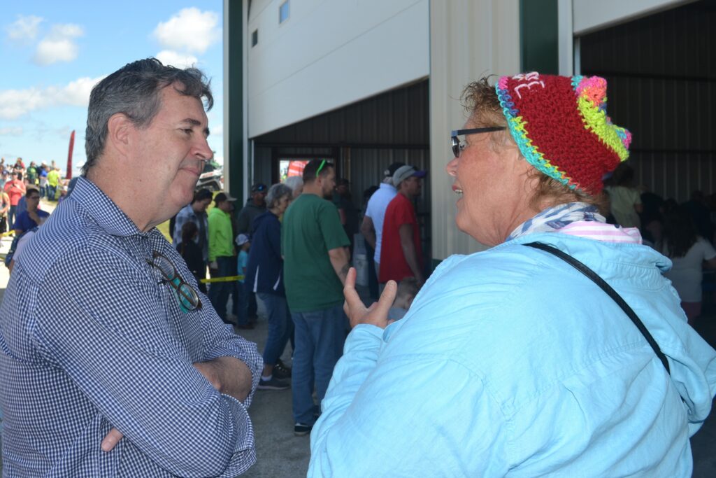 Joel Brennan listens as Rosemary Verheyen of Shebogyan tells him about her concerns at the Sheboygan County Dairy Breakfast on June 20, 2026. (Photo by Erik Gunn/Wisconsin Examiner)