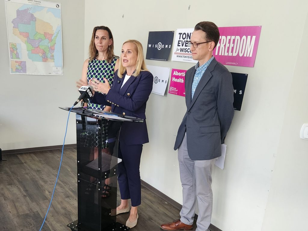 Secretary of State Sarah Godlewski, who is running for lieutenant governor, speaks at a press conference Wednesday, July 1, at Wisconsin Democratic Party headquarters, flanked by Sen. Melissa Ratcliff and Rep. Mike Bare. (Photo by Erik Gunn/Wisconsin Examiner)