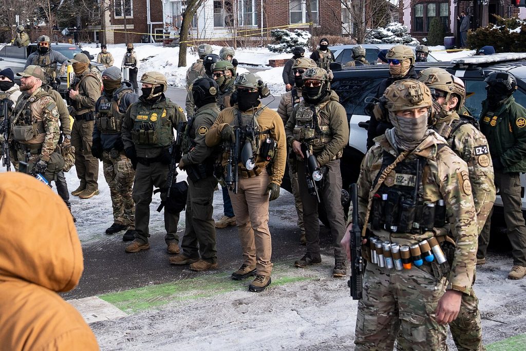 ICE agents in Minneapolis in January 2026. Chad Davis, [1], CC BY 4.0 <https://creativecommons.org/licenses/by/4.0>, via Wikimedia Commons