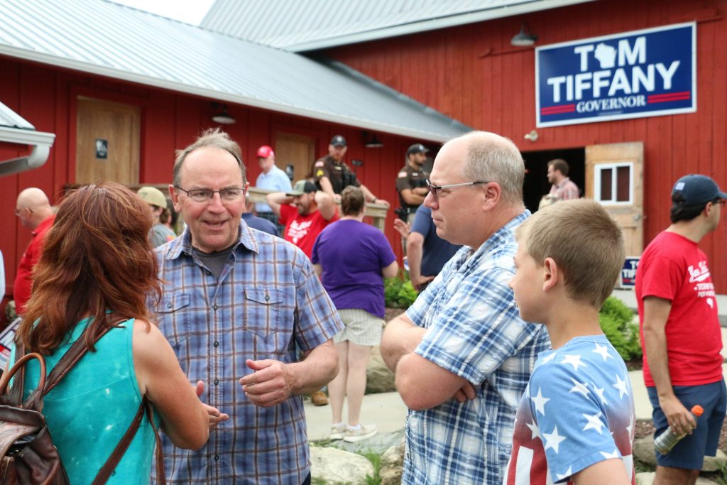 Republican Congressman Tom Tiffany talks with supporters at his gubernatorial campaign’s “Freedom Fest” event at West Bend’s Elderberry Manor wedding barn June 28, 2026. Rich Kremer/WPR