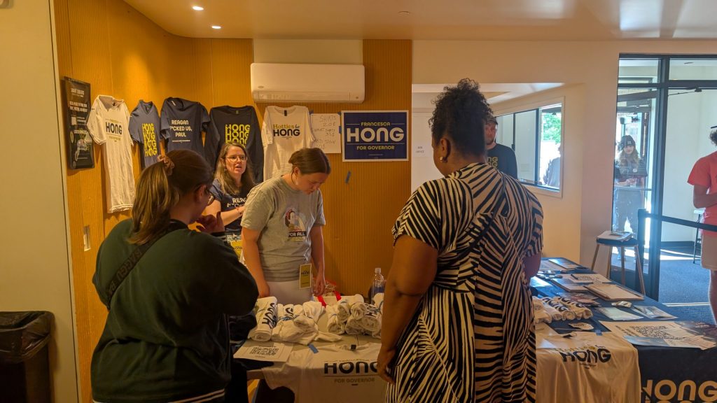 Hong sells t-shirts with phrases like “Reagan F*cked Us, Paul” and “Hotties for Hong” at the Madison rally. (Photo by Baylor Spears/Wisconsin Examiner)