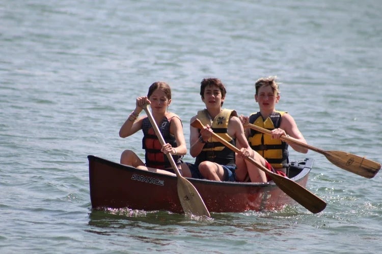 Campers paddle a canoe at Phantom Lake YMCA Camp in Mukwonago, Wisconsin. The camp has been running for 130 years, making it one of the oldest in the country. Photo courtesy of Phantom Lake YMCA Camp