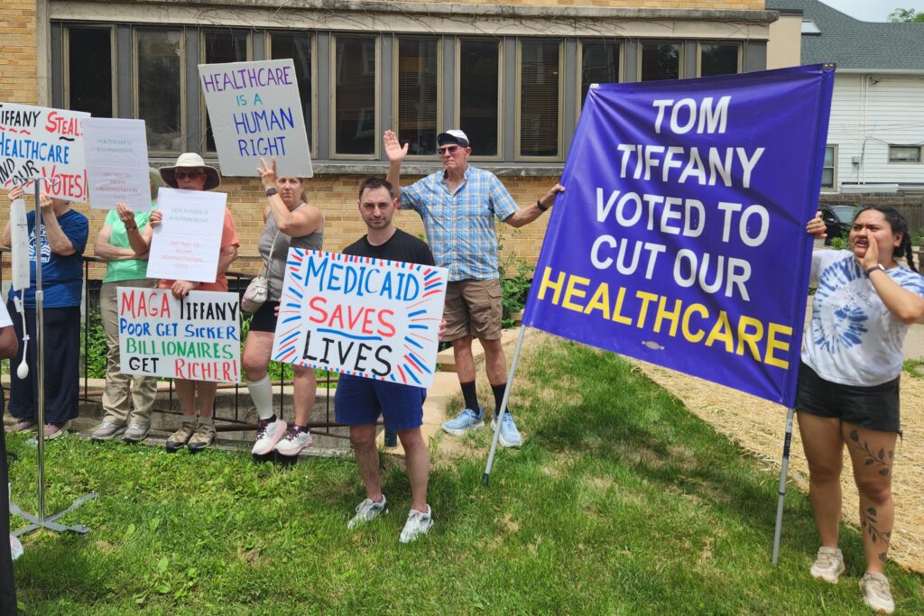 Protesters outside the Wisconsin Republican offices in Madison Tuesday, June 30, call attention to gubernatorial candidate Tom Tiffany's vote last year for HR 1. (Photo by Erik Gunn/Wisconsin Examiner)