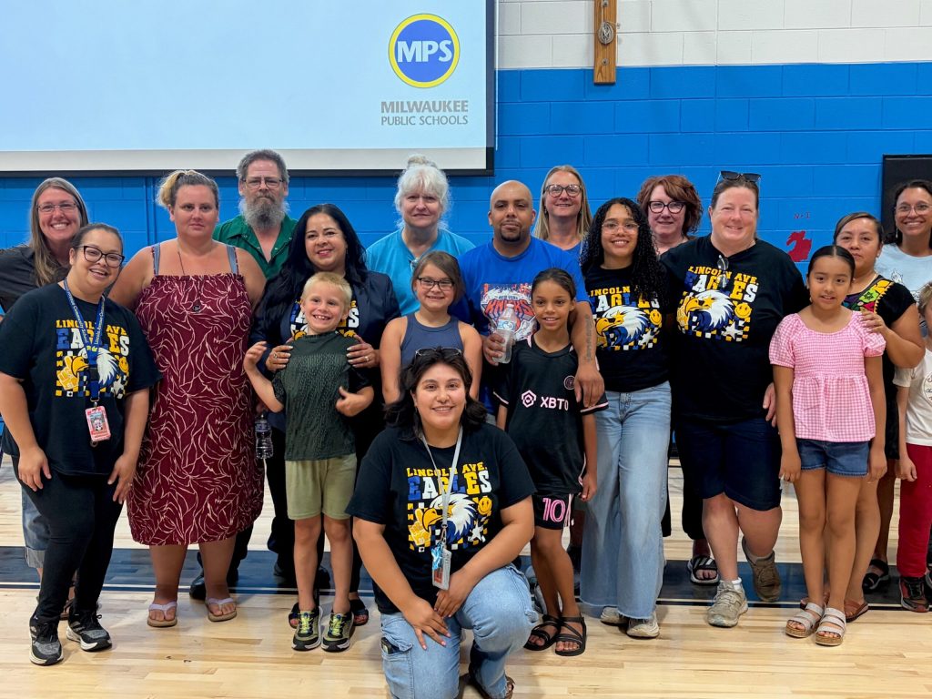 Staff members and families from Lincoln Avenue School at a community meeting at Rogers Street Academy in Milwaukee, Wis. on July 13, 2026. Corrinne Hess/WPR