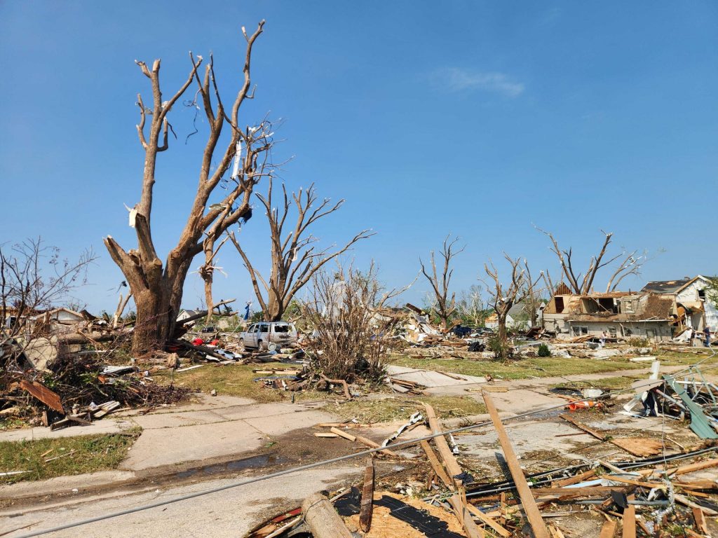 Trees are left bare and homes show severe damage in Menasha, Wis. after the area was hit with a tornado on Monday July 27, 2026. Joe Schulz/WPR