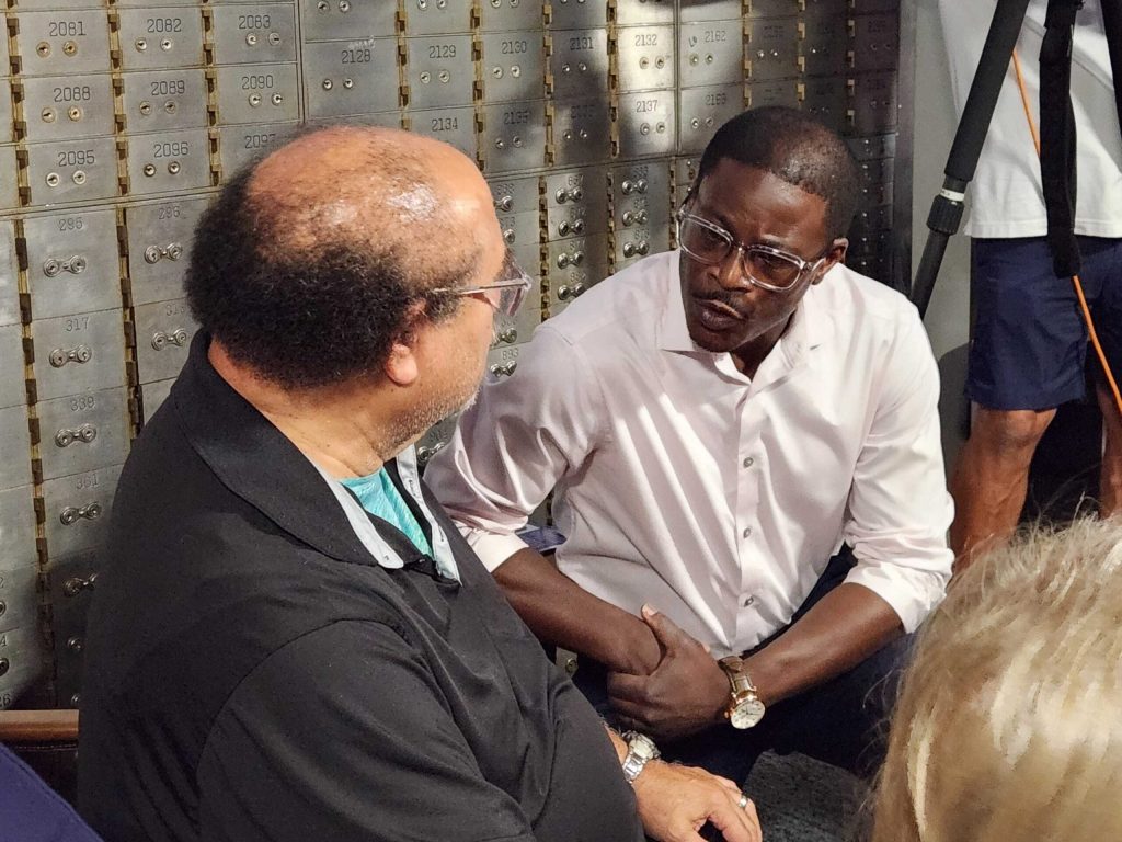 Milwaukee County Executive David Crowley, right, speaks with Clifford Stephens of Appleton before taking the stage at a campaign rally on Monday, Aug. 3, 2026, in the Fox Valley. Joe Schulz/WPR
