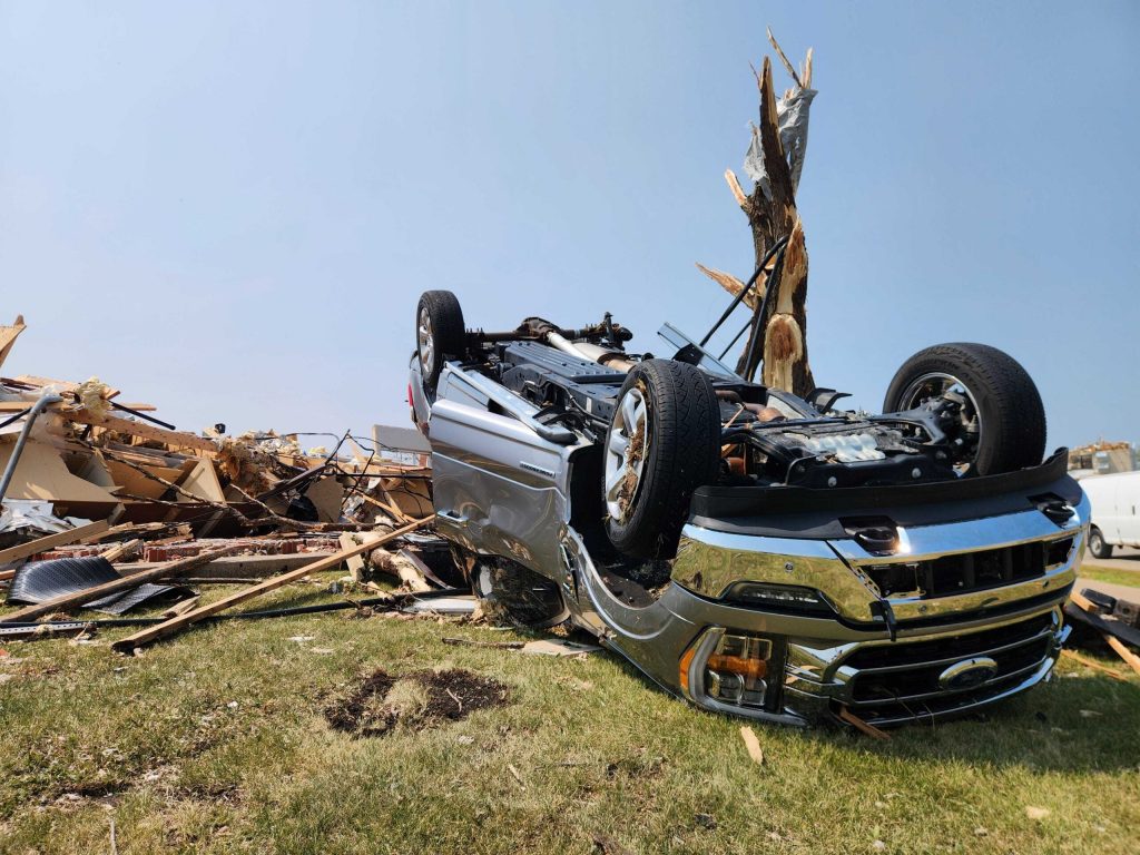 A car is flipped over among damage and debris in Menasha, Wis. on July 28, 2026 after a tornado tore through the area on Monday July 27, 2026. Joe Schulz/WPR
