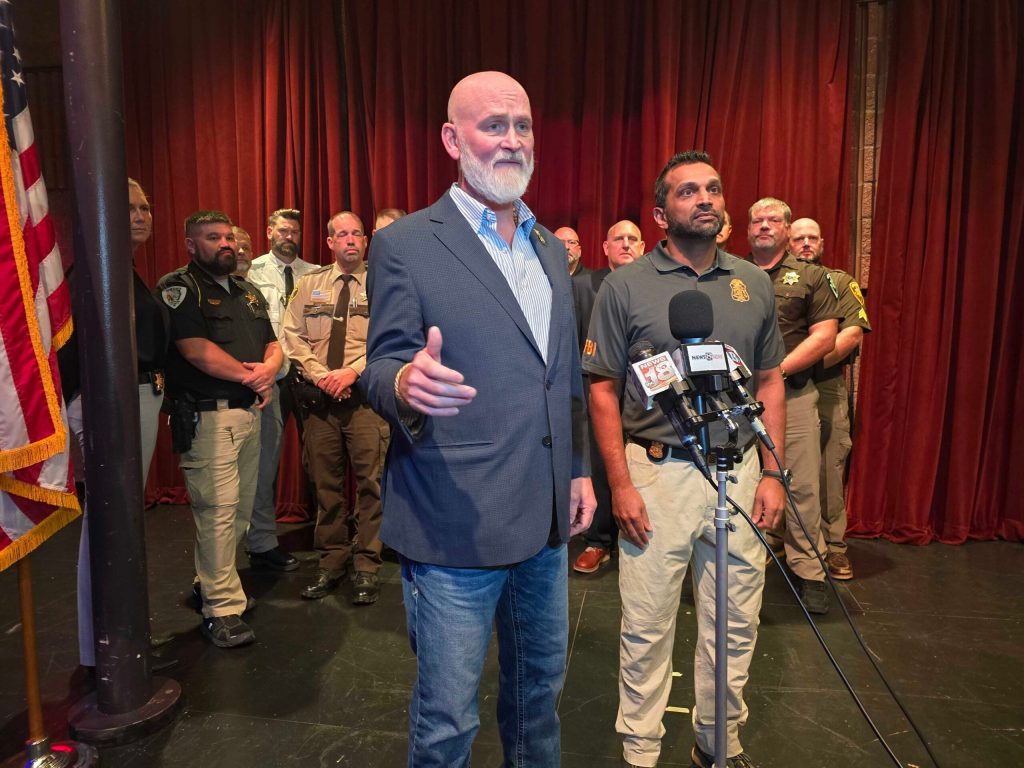 Republican congressman Derrick Van Orden (left) appeared in Eau Claire Monday with FBI Director Kash Patel (right) for a “fireside chat” with around 50 local law enforcement members. Patel’s visit was the 10th by a member of President Donald Trump’s administration during Van Orden’s reelection campaign. Rich Kremer/WPR