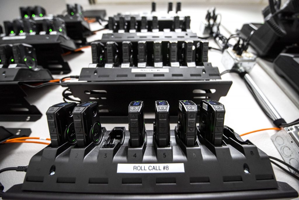 Body cameras are docked onto charging stations Tuesday, April 20, 2021, at the Wauwatosa police department. Angela Major/WPR