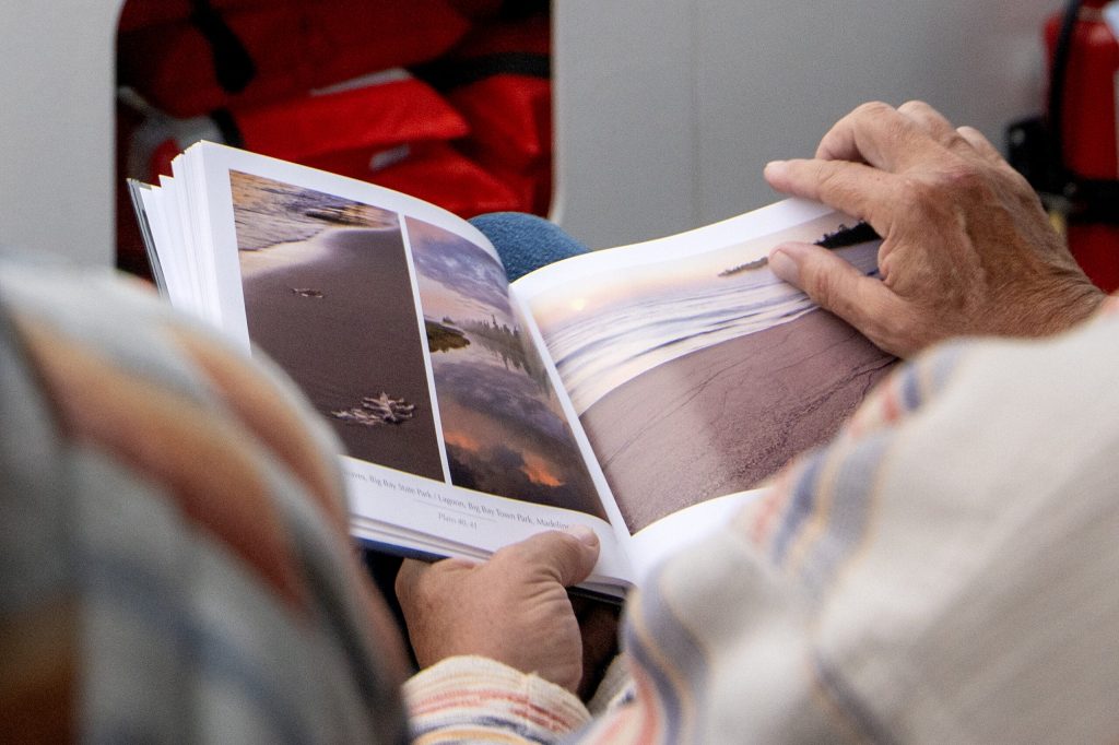 A book features scenic photos of the Apostle Islands on Wednesday, July 8, 2026, in Bayfield, Wis. Angela Major/WPR