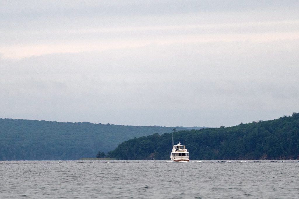 A boat travels near the Apostle Islands on Wednesday, July 8, 2026, in Bayfield, Wis. Angela Major/WPR