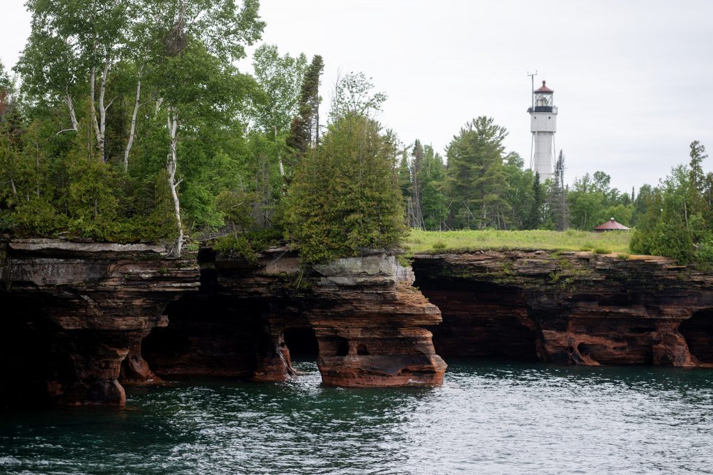 A lighthouse stands above the trees Wednesday, July 8, 2026, at the Apostle Islands in Bayfield, Wis. Angela Major/WPR