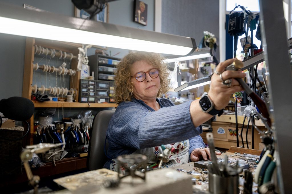 Lissa Flemming works in her shop, Silverwaves Jewelry, on Wednesday, July 8, 2026, in Bayfield, Wis. Angela Major/WPR