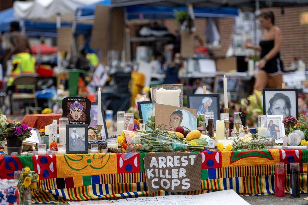 A memorial for Corey Ruiz, a man who was shot and killed by Madison police, fills the Williamson Street intersection where he died Monday, July 27, 2026, in Madison, Wis. Angela Major/WPR