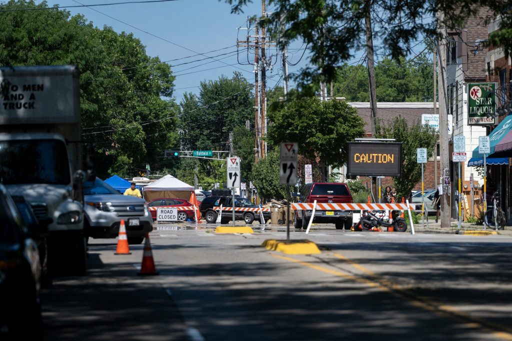 A sign cautions drivers headed toward an encampment Monday, Aug. 3, 2026, in Madison, Wis., which is occupied in response to Madison police shooting and killing Corey Ruiz. Angela Major/WPR