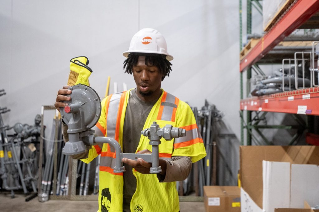 Mickey Critton explains the tools he uses on the job Wednesday, Aug. 12, 2026, at We Energies in West Allis, Wis. Angela Major/WPR