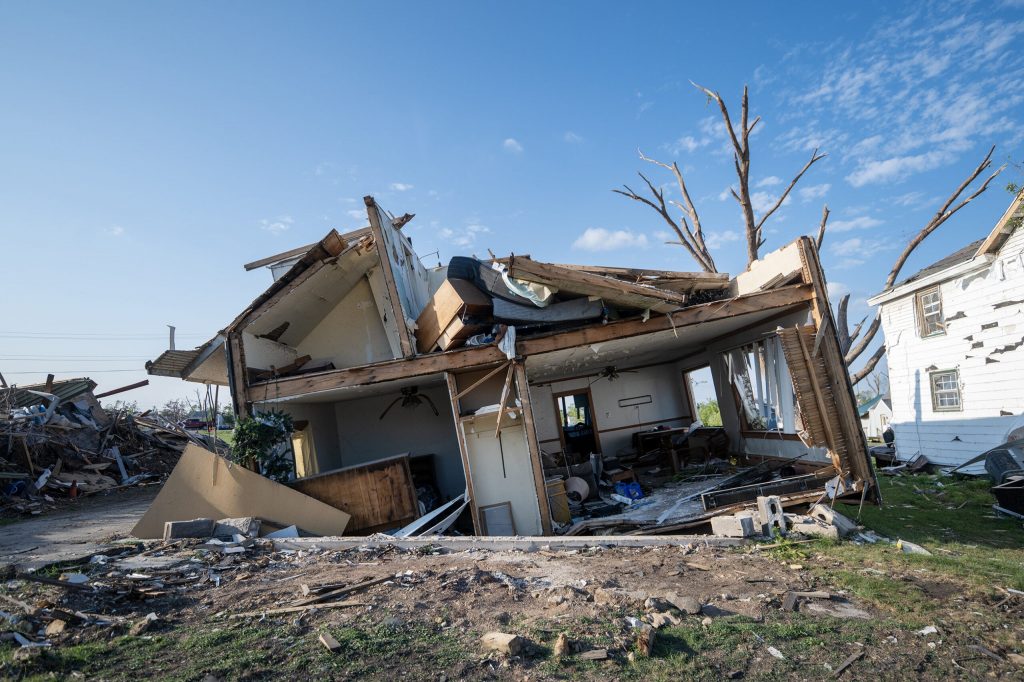 A home on 3rd Street is sunken into the ground after being damaged by a tornado Tuesday, Aug. 25, 2026, in Menasha, Wis. Angela Major/WPR