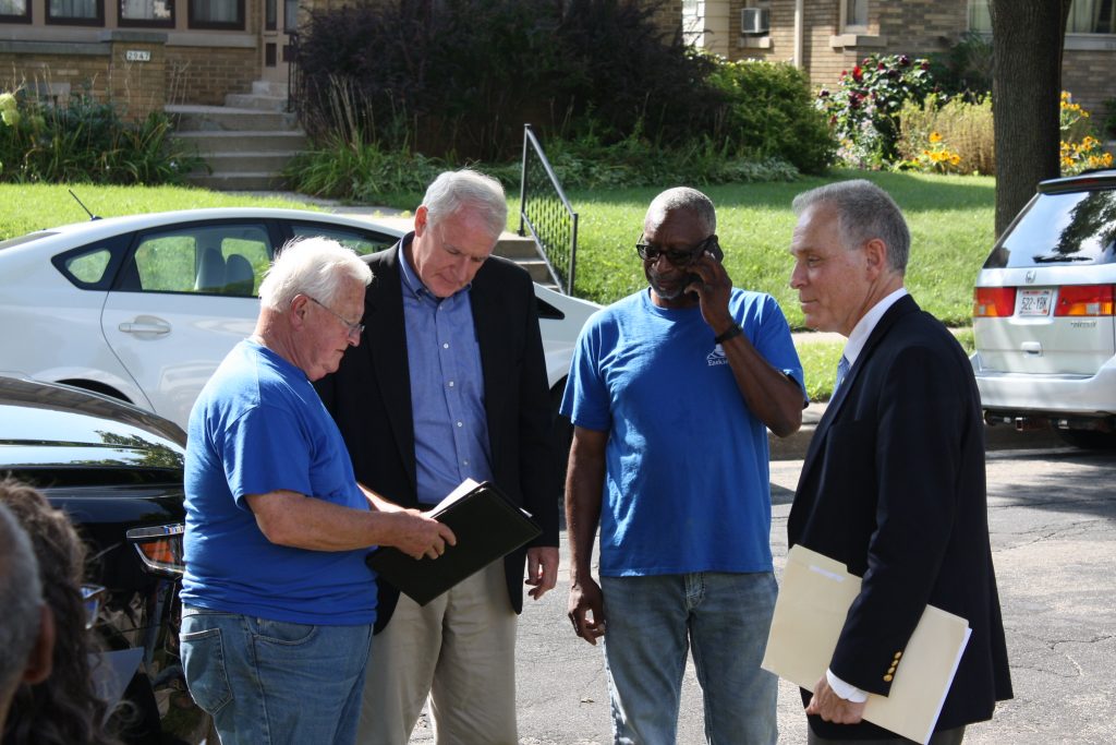 (From left) Don Utech, former Mayor Tom Barrett, Jim Gaillard and Jeff Fleming stand outside 2946 N. 46th St., a property Ezekiel Community Development Corp. acquired through the Milwaukee Employment/Renovation Initiative program in August 2017. (NNS file photo)