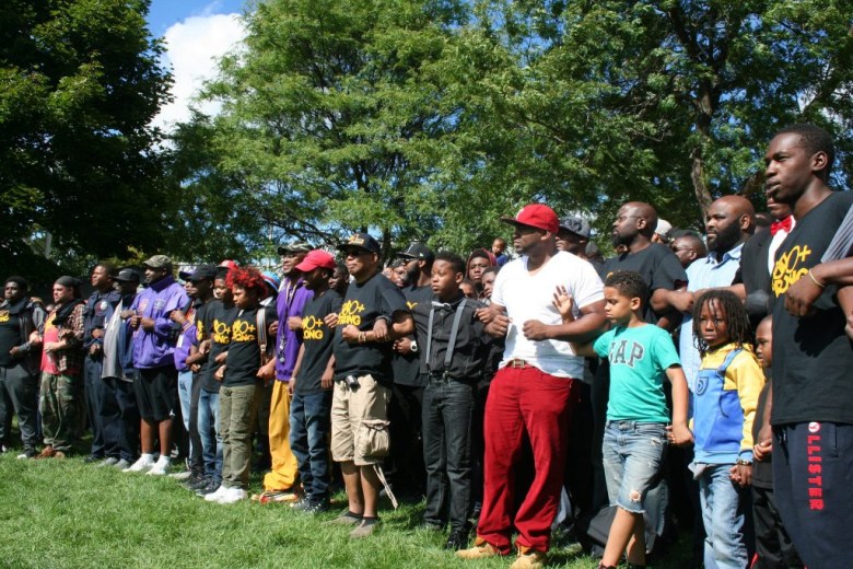 Black men and boys lock arms at a rally in Milwaukee’s Sherman Park neighborhood a month after the uprising in 2016. (NNS file photo)