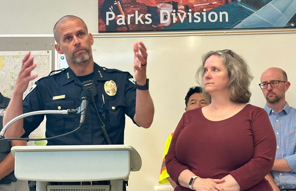 Police Chief John Patterson, left, and Madison Mayor Satya Rhodes-Conway address reporters about the Williamson Street protest encampment on Wednesday, Aug. 5, 2026 in Madison, Wis. Anya van Wagtendonk/WPR