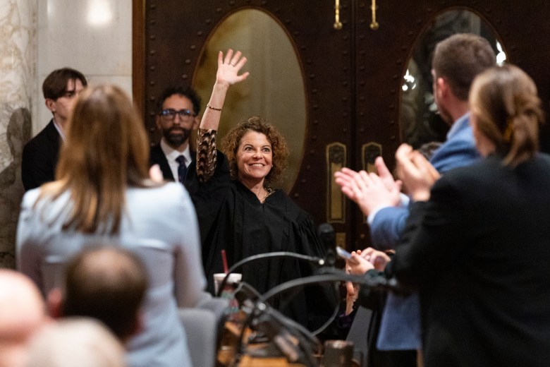 Wisconsin Supreme Court Justice Rebecca Dallet waves while being announced as Wisconsin Gov. Tony Evers prepares to deliver his final State of the State address at the Wisconsin State Capitol on Feb. 17, 2026, in Madison, Wis. (Joe Timmerman / Wisconsin Watch)