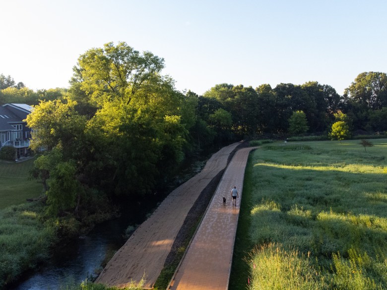 An aerial view shows the tree-lined Yahara River near Sunnybrook Park in DeForest, Wis., July 14, 2026. (Kayla Wolf for Wisconsin Watch)