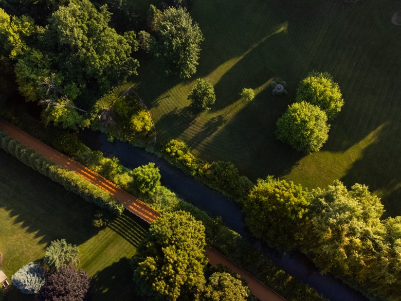 An aerial view shows the tree-lined Yahara River near Sunnybrook Park in DeForest, Wis., July 14, 2026. (Kayla Wolf for Wisconsin Watch)
