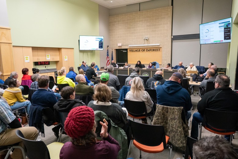 Members of the public attend a DeForest Village Board meeting at Village Hall in DeForest, Wisconsin, on Jan. 20, 2026. Public opposition helped derail a proposed $12 billion QTS data center that village officials had negotiated with the developer. (Kayla Wolf for Wisconsin Watch)