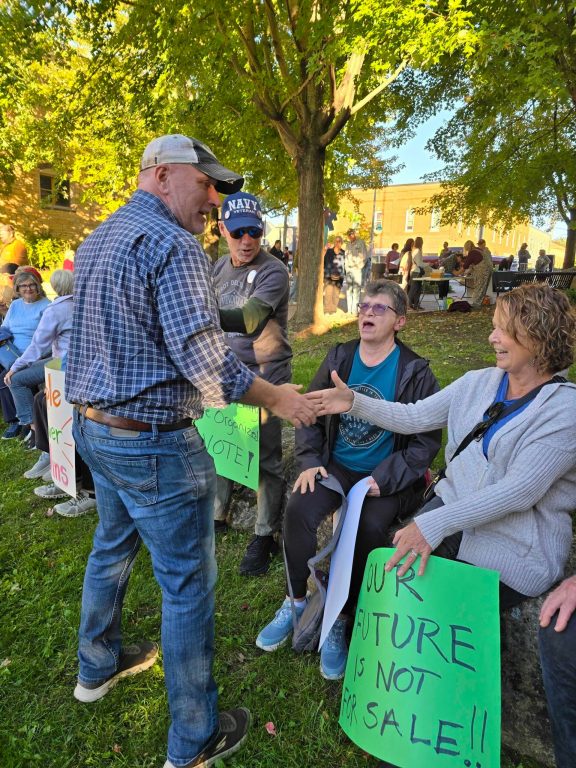 30th Assembly District Democratic candidate Kevin Knoke mingles with the crowd at a Sept. 23 rally in River Falls opposing a 2023 data center tax break authored by Republican state Rep. Shannon Zimmerman.  Rich Kremer/WPR 