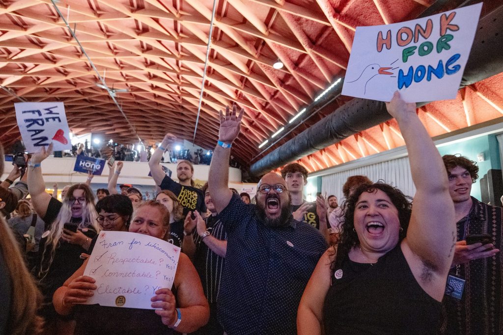 Attendees cheer as results come in for state Rep. Francesca Hong and her opponent Milwaukee County Executive David Crowley on Tuesday, Aug. 11, 2026, at Atwood Music Hall in Madison, Wis. Angela Major/WPR