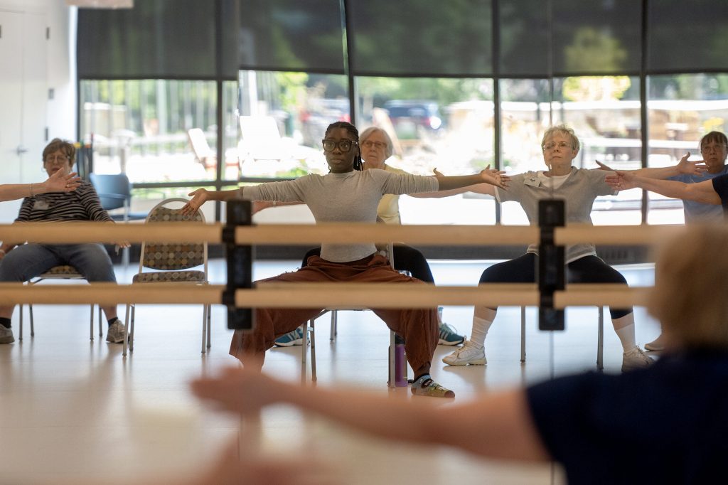 Marquette University PhD student Daija Holliday guides residents through a class of chair yoga Saturday, Aug. 22, 2026, at St. Camillus in Milwaukee, Wis. Angela Major/WPR