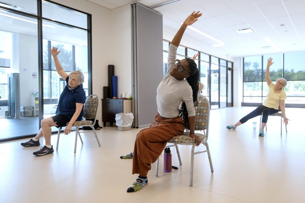 Marquette University PhD student Daija Holliday leads a chair yoga class Saturday, Aug. 22, 2026, at St. Camillus in Milwaukee, Wis. Angela Major/WPR