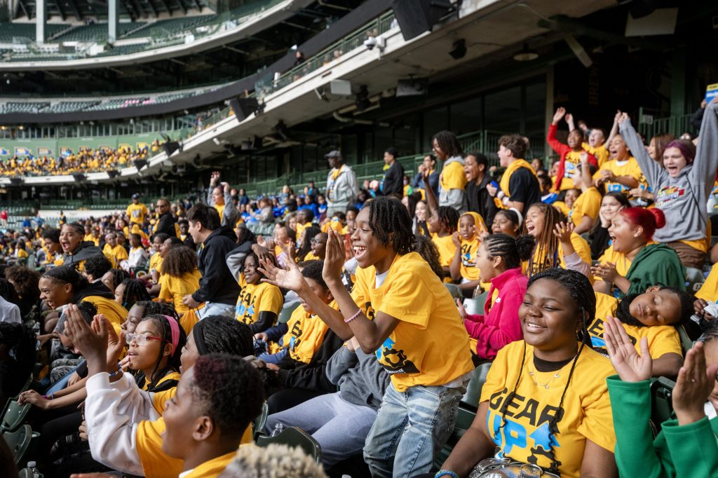 Milwaukee students cheer as their schools are shouted out at the kickoff event for GEAR UP, a program that supports college and career advancement, on Wednesday, Sept. 23, 2026, at American Family Field in Milwaukee, Wis. Angela Major/WPR