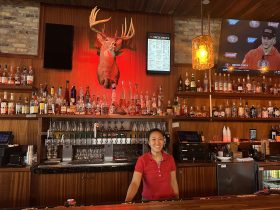 Michelle Le behind the bar at Uncle Buck's on Third. Photo taken by Lauren Hafeman.