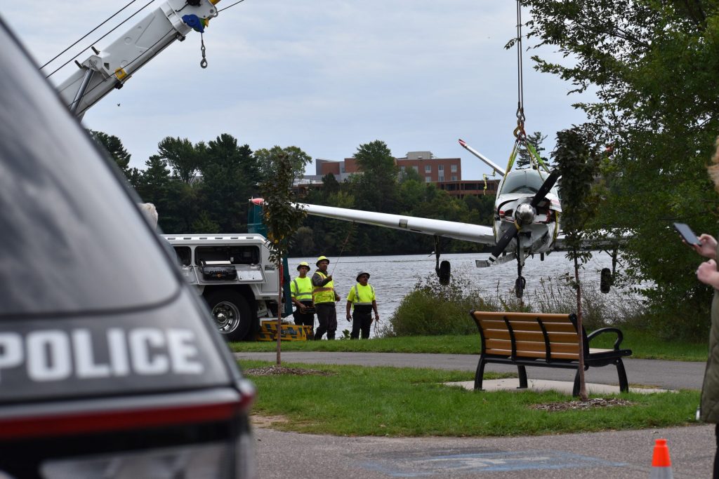 Finally back to dry land, the aircraft hangs in the air as crews work to move it toward the loading zone for the truck. Avery Martinez/WPR