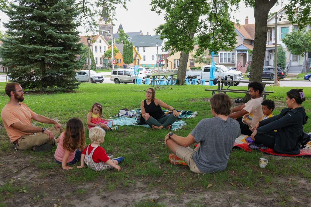 Holly Kingsbury leads a children’s yoga class at Walker Square Park during the market on Aug. 9. (Photo by Jonathan Aguilar / Milwaukee Neighborhood News Service / CatchLight Local)