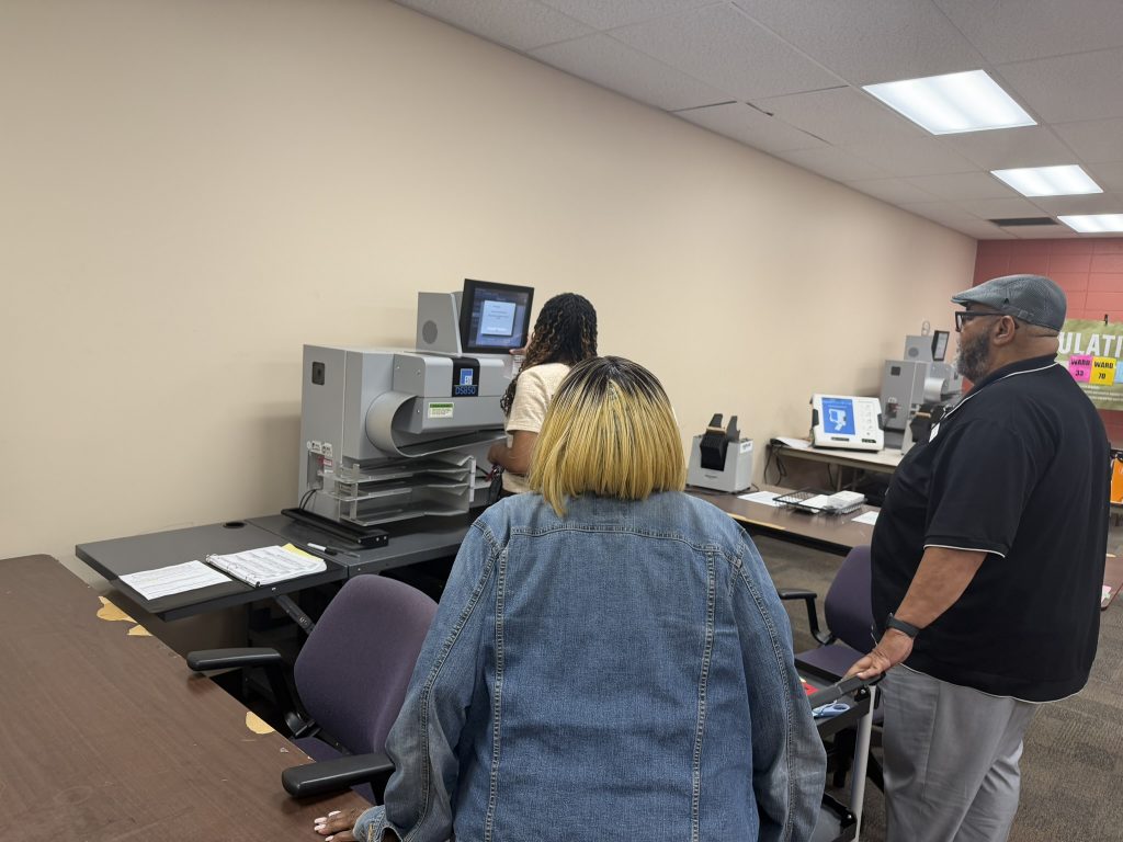 Deputy Director Maricha Harris exports a file during the Aug. 11 election. Photo by Jeramey Jannene.