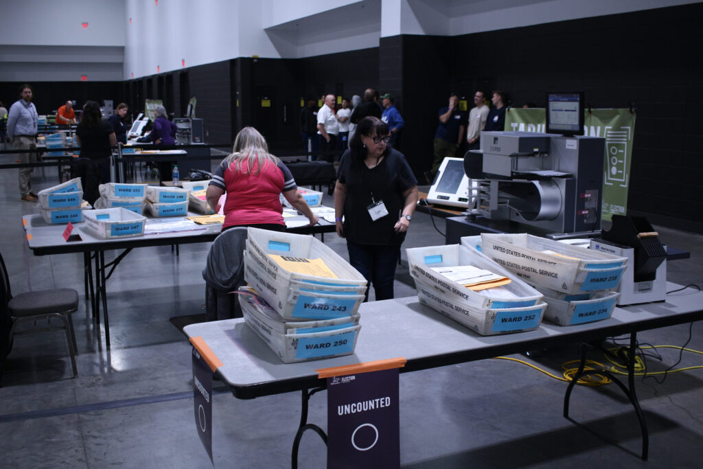 Boxes of ballots wait to be counted at Milwaukee's central count on Election Day 2024. (Photo by Henry Redman/Wisconsin Examiner)