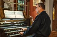 Organist Michael Batcho prepares for the "Songs of Remembrance" concert. Photo by Rick Bate.