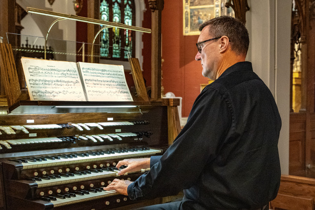 Organist Michael Batcho prepares for the "Songs of Remembrance" concert. Photo by Rick Bate.