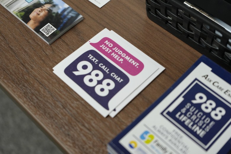 Cards used to spread awareness about the 988 Suicide and Crisis Lifeline are seen at the Family Services of Northeast Wisconsin’s office in Green Bay, Wis., on Sept. 3, 2026. (Astrid Code / Wisconsin Watch)