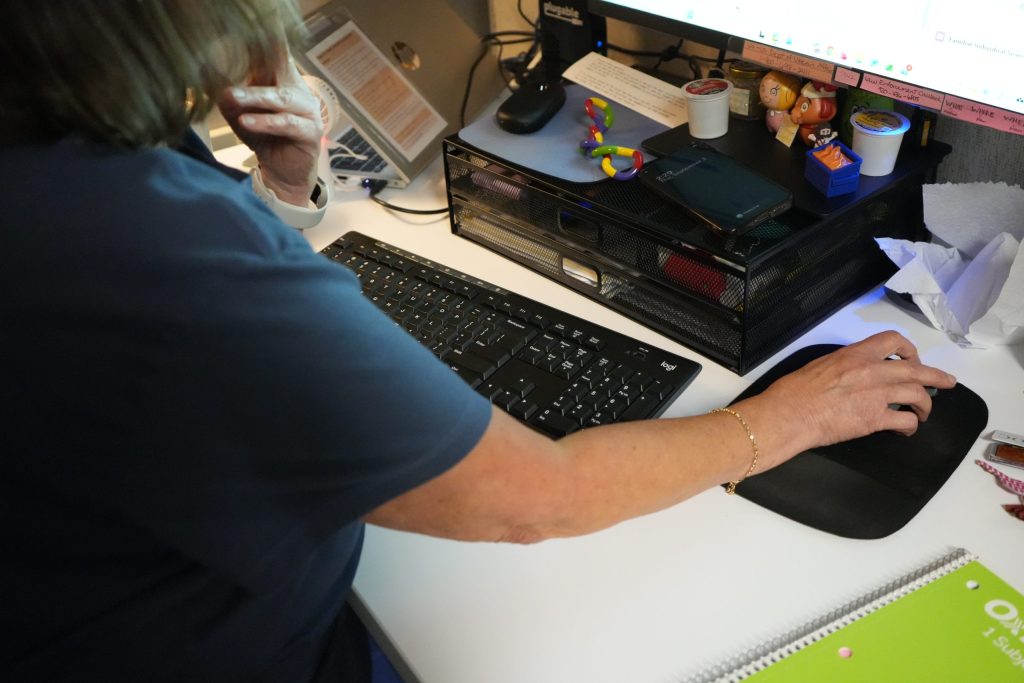 A counselor responds to calls and chats to the 988 Suicide and Crisis Lifeline at Family Services of Northeast Wisconsin in Green Bay, Wis., on Sept. 3, 2026. The service has received more than 345,000 texts or calls since it launched in July 2022. (Astrid Code / Wisconsin Watch)