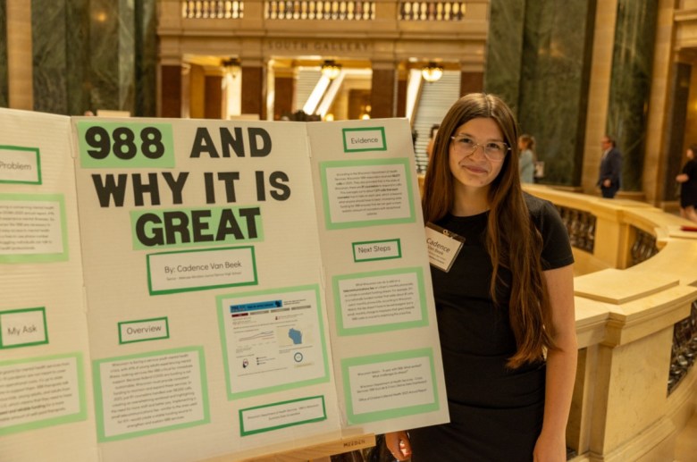 Cadence Van Beek presents her 988 funding recommendation at the state Capitol in Madison with the Office of Children’s Mental Health in May 2026. (Courtesy of Cadence Van Beek)