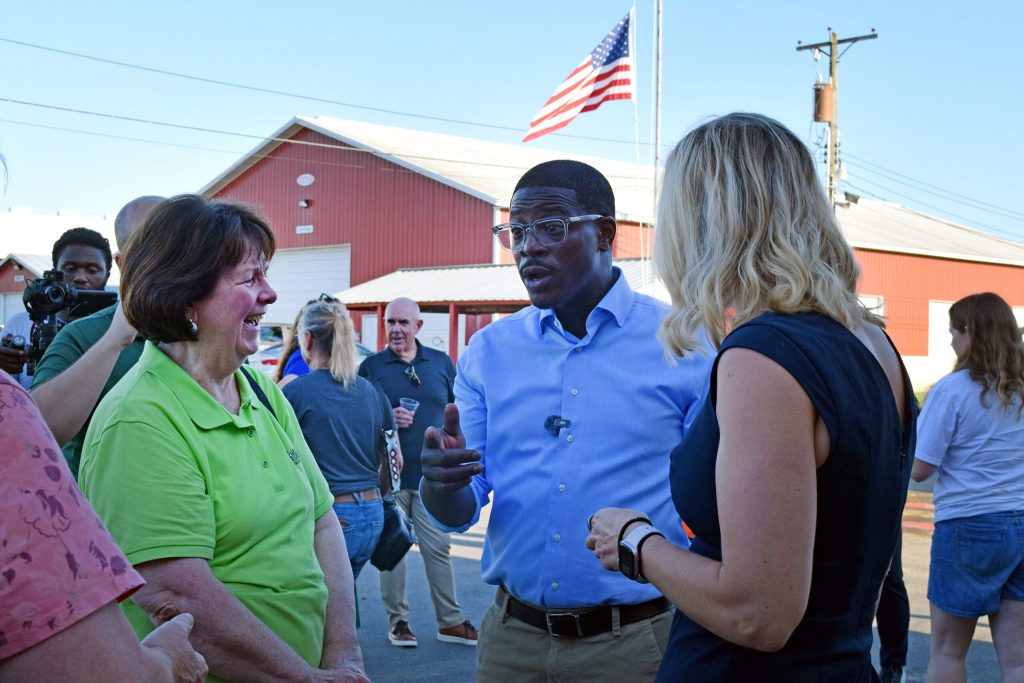 Milwaukee County Executive David Crowley, the Democratic candidate for governor, talks with La Crosse voter Margaret Wood during Democrats’ annual corn roast at the La Crosse Interstate Fair grounds on Sept. 2, 2026. Hope Kirwan/WPR