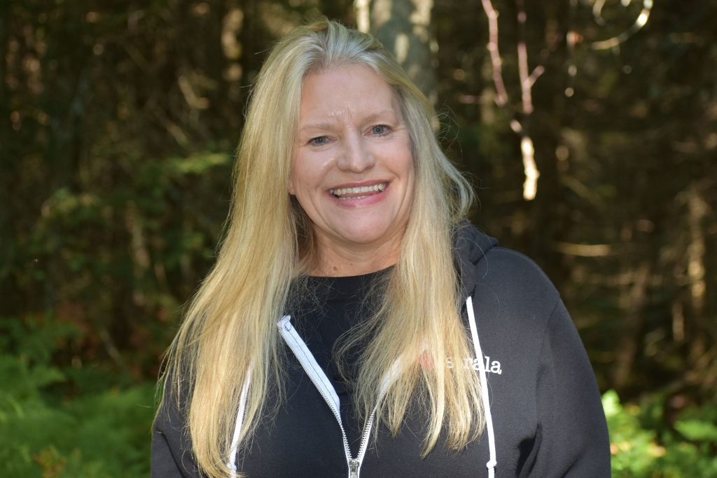 Heather Fletcher of Eagle River said she tried forest bathing for the first time after experiencing a stroke and brain aneurysm that ruptured twice in 2022. She said forest bathing helps bring her back into balance during a guided walk on Aug. 8, 2026. Danielle Kaeding/WPR