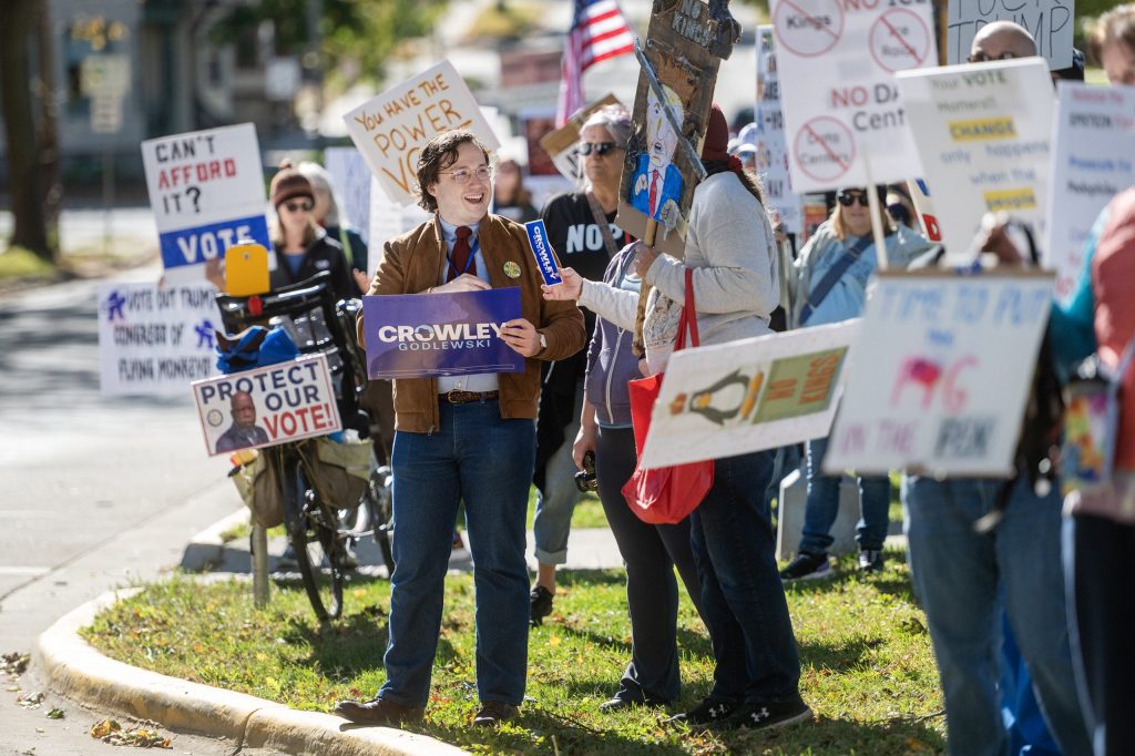 Protesters hold signs in support of Democratic gubernatorial candidate Milwaukee County Executive David Crowley on Saturday, Oct. 17, 2026, during a No Kings protest in Madison, Wis. Angela Major/WPR