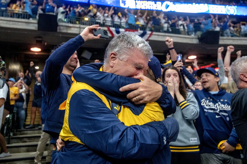 Milwaukee Brewers fans Dennis and Kay Wentland embrace after the team wins the World Series on Wednesday, Oct. 28, 2026, during a watch party at American Family Field in Milwaukee, Wis. Angela Major/WPR