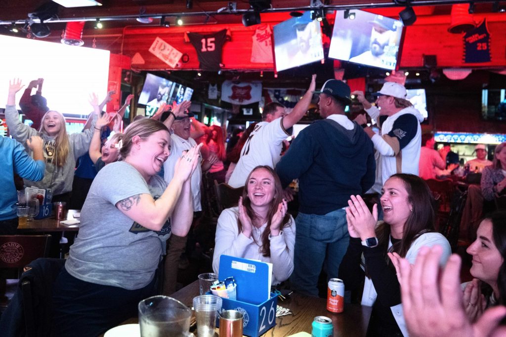 Milwaukee Brewers fans watching from Major Goolsby’s, a Milwaukee bar, react as the team plays the Los Angeles Dodgers on Thursday, Oct. 15, 2026, in Milwaukee, Wis. Angela Major/WPR