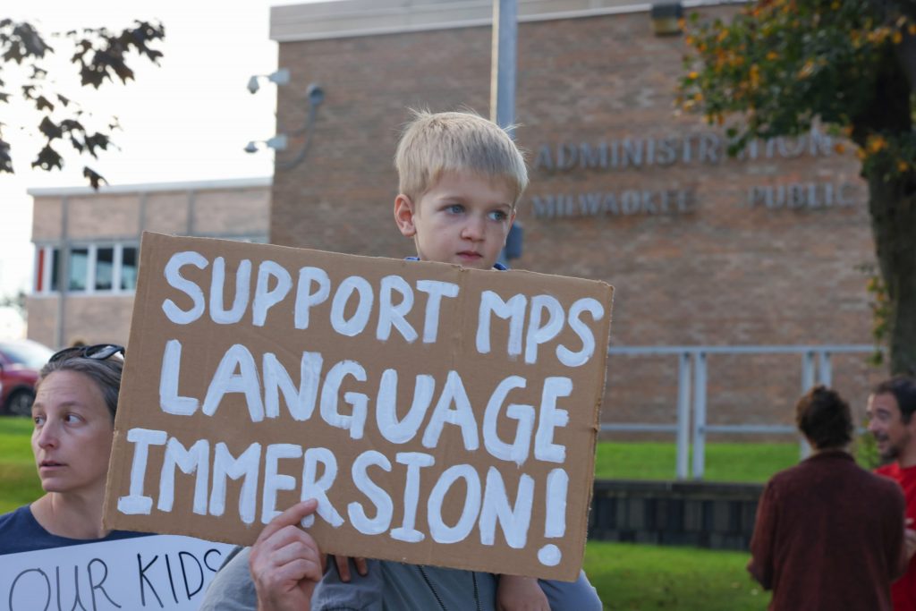 A child holds a sign supporting the Milwaukee French Immersion School during a protest. (Photo by Jonathan Aguilar / Milwaukee Neighborhood News Service / CatchLight Local)