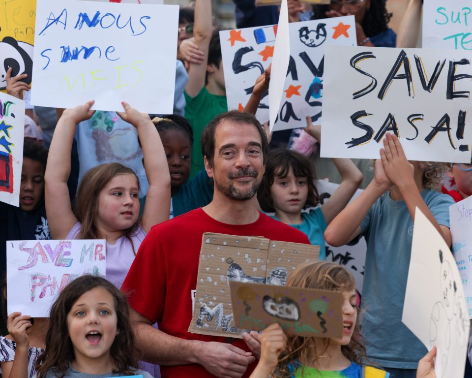 Alexandre Sablonniere stands with students as they protest to save his job at the Milwaukee French Immersion School. (Photo by Jonathan Aguilar / Milwaukee Neighborhood News Service / CatchLight Local)